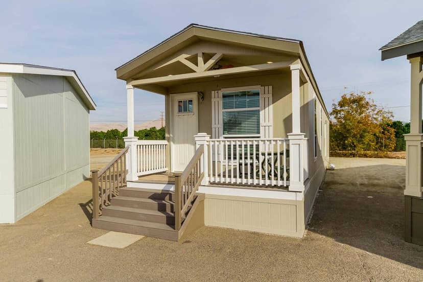 A finished manufactured home set on its foundation with skirting and steps